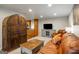 Comfortable living room area with leather couch, wooden coffee table and built in shelving leading to the kitchen at 2341 Elmwood Se Cir, Atlanta, GA 30339