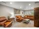 Inviting living room with comfortable leather seating, neutral carpet and ample natural light at 2341 Elmwood Se Cir, Atlanta, GA 30339