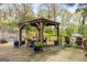 Backyard patio with covered outdoor dining and mature trees at 2341 Elmwood Se Cir, Atlanta, GA 30339