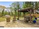 Backyard patio with covered outdoor dining, a shed, and mature trees at 2341 Elmwood Se Cir, Atlanta, GA 30339