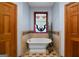 Bathroom featuring a clawfoot tub, tiled floors and walls, and decorative stained glass at 680 Milligan Creek Rd, Roopville, GA 30170