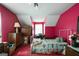 Cozy pink bedroom with a dormer window featuring a bed and wooden furniture at 680 Milligan Creek Rd, Roopville, GA 30170