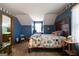 Charming bedroom featuring blue walls and a quilt-covered bed, providing a cozy and inviting retreat at 680 Milligan Creek Rd, Roopville, GA 30170