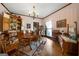 Traditional dining room featuring hardwood floors, pink walls, and antique china cabinet with wooden dining table at 680 Milligan Creek Rd, Roopville, GA 30170