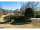 Stone entrance to the property with mature trees and landscaping at 680 Milligan Creek Rd, Roopville, GA 30170