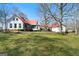 Sprawling property showcasing a well-maintained lawn and multiple sections of the home connected by covered walkways at 680 Milligan Creek Rd, Roopville, GA 30170