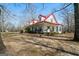 Inviting two-story home with a spacious porch, complete with rocking chairs and porch swings, perfect for relaxing at 680 Milligan Creek Rd, Roopville, GA 30170
