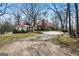 Charming two-story home featuring a red metal roof, dormer windows, and a spacious front yard at 680 Milligan Creek Rd, Roopville, GA 30170