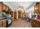 Spacious eat-in kitchen boasts tiled floors, wooden cabinets, and modern appliances with kitchen table at 680 Milligan Creek Rd, Roopville, GA 30170
