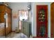 Quaint kitchen featuring vintage refrigerator, storage, and a decorative pantry behind a red door at 680 Milligan Creek Rd, Roopville, GA 30170