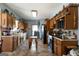 Long kitchen features wood cabinets, tiled floors, updated appliances, and butcher block island at 680 Milligan Creek Rd, Roopville, GA 30170
