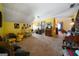 Spacious living room with natural light, yellow walls, and classic furnishings, offering a comfortable space at 680 Milligan Creek Rd, Roopville, GA 30170