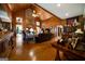 Spacious living room features wood-paneled walls, high ceilings, brick fireplace, and hardwood flooring at 680 Milligan Creek Rd, Roopville, GA 30170