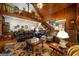 Spacious living room featuring a loft, wood ceiling, staircase, and large leather sofa at 680 Milligan Creek Rd, Roopville, GA 30170