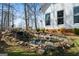 Scenic backyard pond featuring a small waterfall and natural stone landscaping, perfect for relaxation at 680 Milligan Creek Rd, Roopville, GA 30170