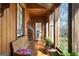 Inviting sunroom with wood paneling, ample seating, and a view of the garden at 680 Milligan Creek Rd, Roopville, GA 30170