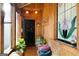Enclosed sunroom with wooden walls, plants, bench, and stained glass details at 680 Milligan Creek Rd, Roopville, GA 30170