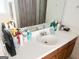 Bathroom vanity featuring sink, mirror and toiletries at 122 Lake Ter, Mcdonough, GA 30253