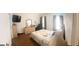 Comfortable bedroom featuring a bed, dresser, and a large window for natural light at 122 Lake Ter, Mcdonough, GA 30253