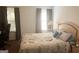 A bedroom showcasing a cozy bed with pillows and a window with gray curtains at 122 Lake Ter, Mcdonough, GA 30253