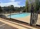 Fenced community pool with a view of the lake and private property signage at 122 Lake Ter, Mcdonough, GA 30253