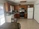 Functional kitchen featuring a refrigerator, oven, and wood cabinetry at 122 Lake Ter, Mcdonough, GA 30253