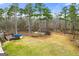 Aerial view of a backyard featuring a large deck and above-ground pool nestled among the trees at 370 Burton Dr, Douglasville, GA 30134