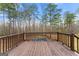 Wooden deck overlooking an inviting above ground pool surrounded by tall trees at 370 Burton Dr, Douglasville, GA 30134