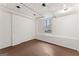 Unfinished basement featuring a window, white walls and ceiling, and dark brown floor at 370 Burton Dr, Douglasville, GA 30134