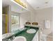 Bathroom boasts double sinks, framed mirror, and natural light from the window at 370 Burton Dr, Douglasville, GA 30134