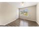 Bedroom offers wood-look flooring, neutral paint, and natural light from the window at 370 Burton Dr, Douglasville, GA 30134