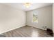 Bedroom features hardwood floors, natural light from the window, and neutral paint at 370 Burton Dr, Douglasville, GA 30134