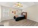 Bedroom features natural light from windows, wood floors and ceiling fan at 370 Burton Dr, Douglasville, GA 30134