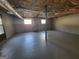 Unfinished basement with concrete floors and block walls provides ample storage space at 1433 Butler St, Jonesboro, GA 30236