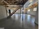 Partially finished basement with staircase, concrete floors, and two small windows at 1433 Butler St, Jonesboro, GA 30236