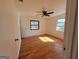 Bright bedroom with hardwood floors, ceiling fan, and plenty of natural light from two windows at 1433 Butler St, Jonesboro, GA 30236