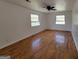 Bright bedroom featuring gleaming hardwood floors and two windows at 1433 Butler St, Jonesboro, GA 30236