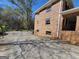 Side view of a brick house with ample parking and mature landscaping at 1433 Butler St, Jonesboro, GA 30236