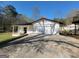 Detached two-car garage with white wooden siding and a concrete driveway at 1433 Butler St, Jonesboro, GA 30236