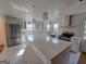 Modern kitchen with a large island, stainless steel appliances, pendant lighting, and white cabinetry at 1433 Butler St, Jonesboro, GA 30236