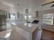 Modern kitchen with a large island, stainless steel appliances, pendant lighting, and white cabinetry at 1433 Butler St, Jonesboro, GA 30236