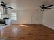 Open living space featuring a ceiling fan, hardwood floors and a white door at 1433 Butler St, Jonesboro, GA 30236