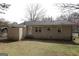 The backyard of the home featuring a brick exterior and some grass at 4242 Timber Valley Ct, Decatur, GA 30032