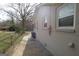 A view of the side of the home, with a painted brick exterior, fence, and walkway at 4242 Timber Valley Ct, Decatur, GA 30032