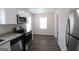Bright kitchen with stainless steel appliances, granite countertops, and wood-look flooring at 4242 Timber Valley Ct, Decatur, GA 30032