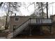 Back of house featuring a large deck with stairs leading down to the backyard at 1897 Madras Ct, Lithonia, GA 30058