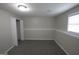 Finished basement with neutral paint and carpet plus a window for ample light at 1897 Madras Ct, Lithonia, GA 30058