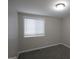 Cozy bedroom featuring neutral colors and a bright window with modern blinds at 1897 Madras Ct, Lithonia, GA 30058