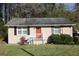 Single-story home with bright red front door, neutral siding, and manicured landscaping at 2336 Polar Rock Ave, Atlanta, GA 30315
