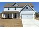 Charming two-story home with light blue siding, a two-car garage, and a well-manicured lawn at 371 Cantrell Drive, Dallas, GA 30157